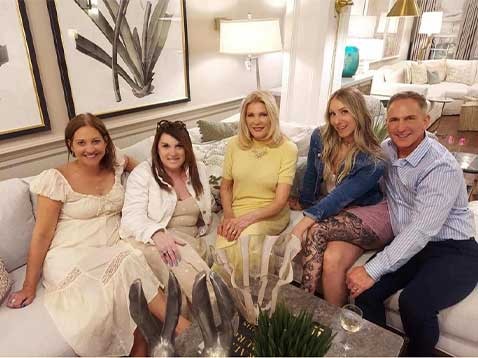 Company staff posing for a photo sitting on a couch